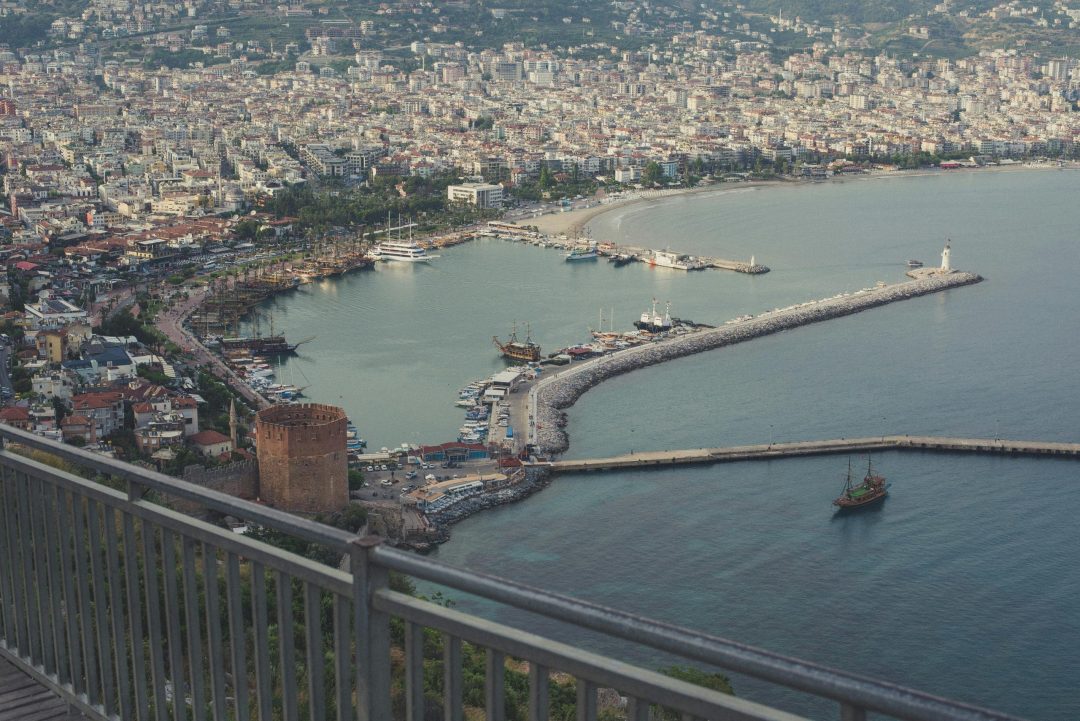 Scenic aerial view of Alanya harbor with boats and cityscape in Turkey.