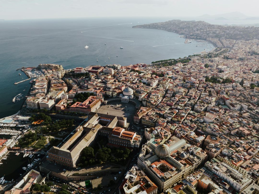 A breathtaking aerial view showcasing Naples, Italy's coastal cityscape and iconic landmarks.